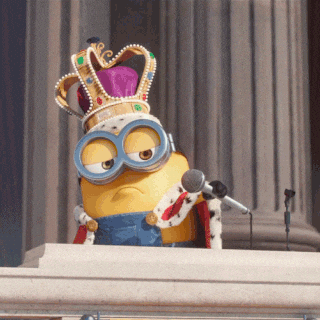 A minion in a crown at a microphone, a smug mic-drop