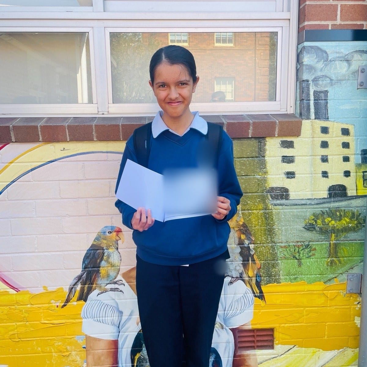 Kinjal, a Year 7 Cuemath student in Australia, smiling outside her school