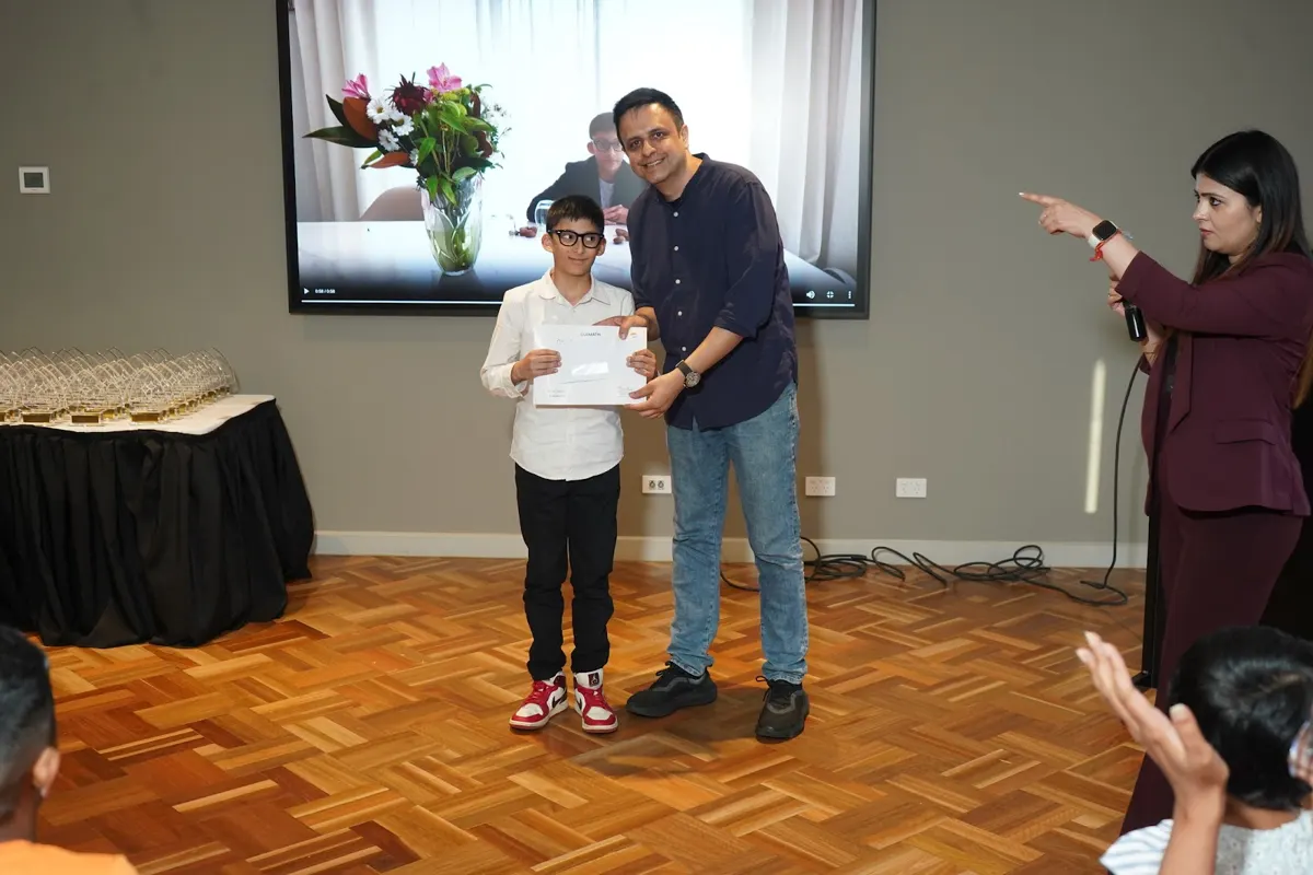 Families applauding as a student receives his certificate in Melbourne