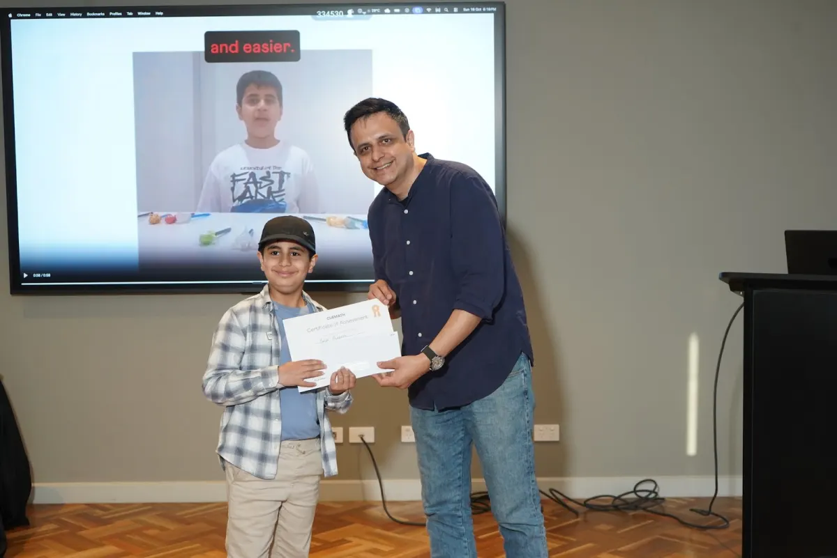A Teach-It-Back winner receiving his certificate on stage in Melbourne